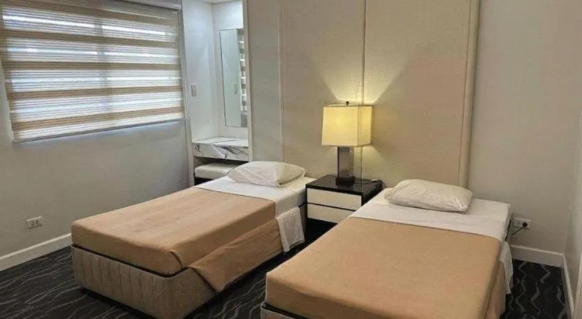 Bed in Amorsolo Mansion Hotel