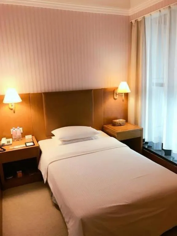 Bed in Culture Plaza Hotel