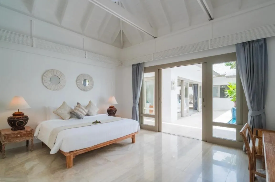 Bed in Miskawaan Beachfront Villas