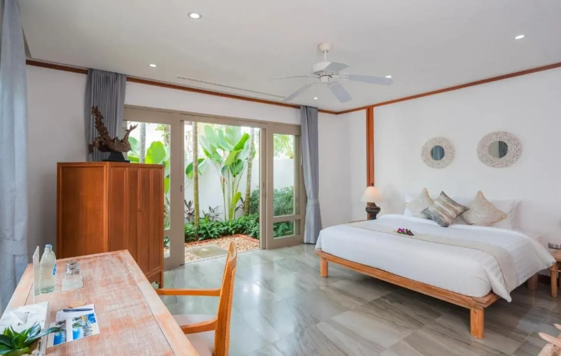 Bed in Miskawaan Beachfront Villas