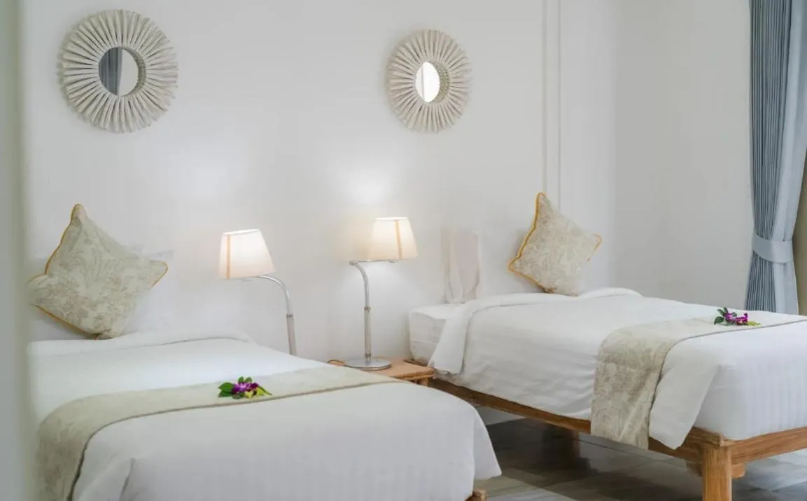 Bed in Miskawaan Beachfront Villas