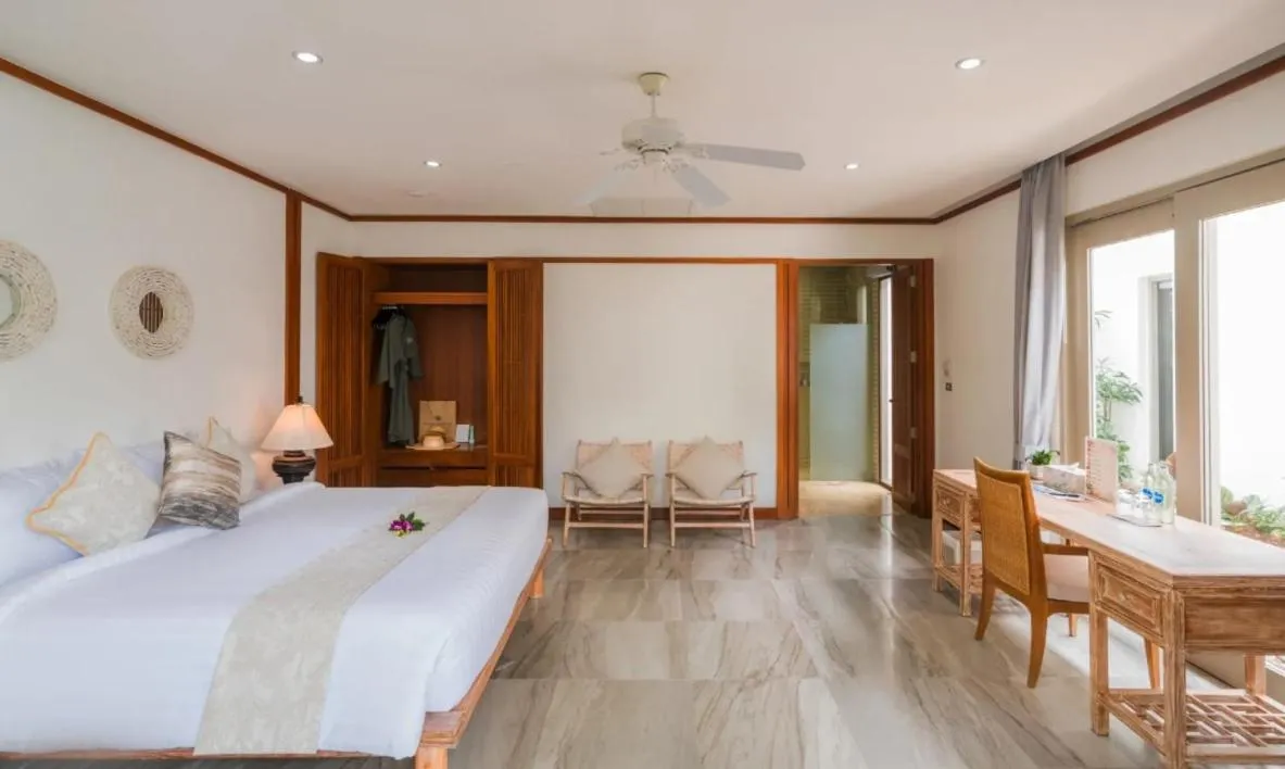 Bed in Miskawaan Beachfront Villas