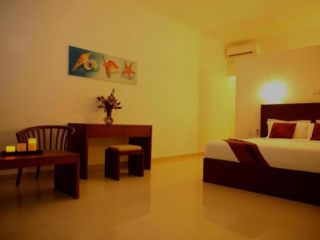 Bed in Whispering Palms Hotel