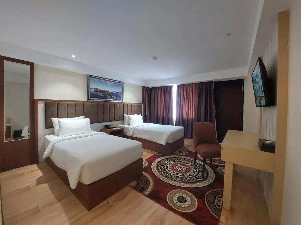 Bed in Grand Qin Hotel Syariah