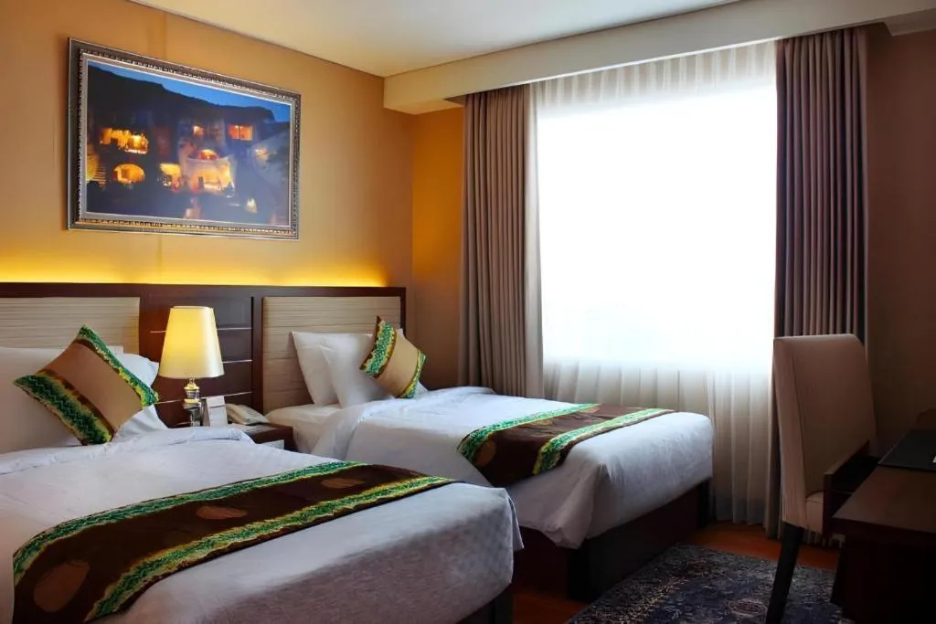 Bed in Grand Qin Hotel Syariah