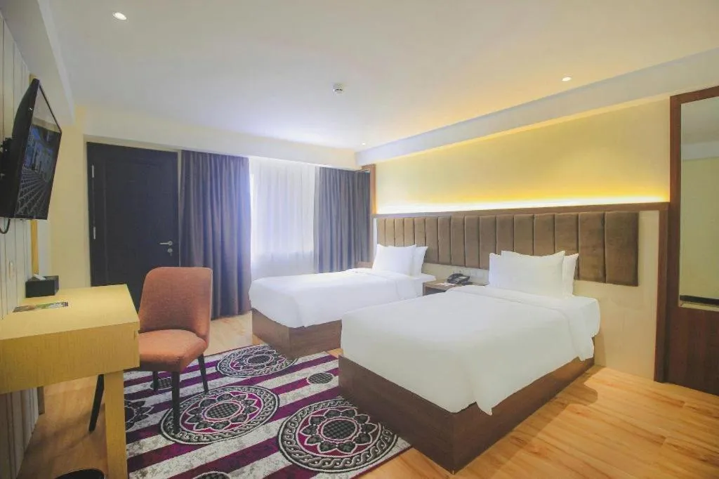 Bed in Grand Qin Hotel Syariah