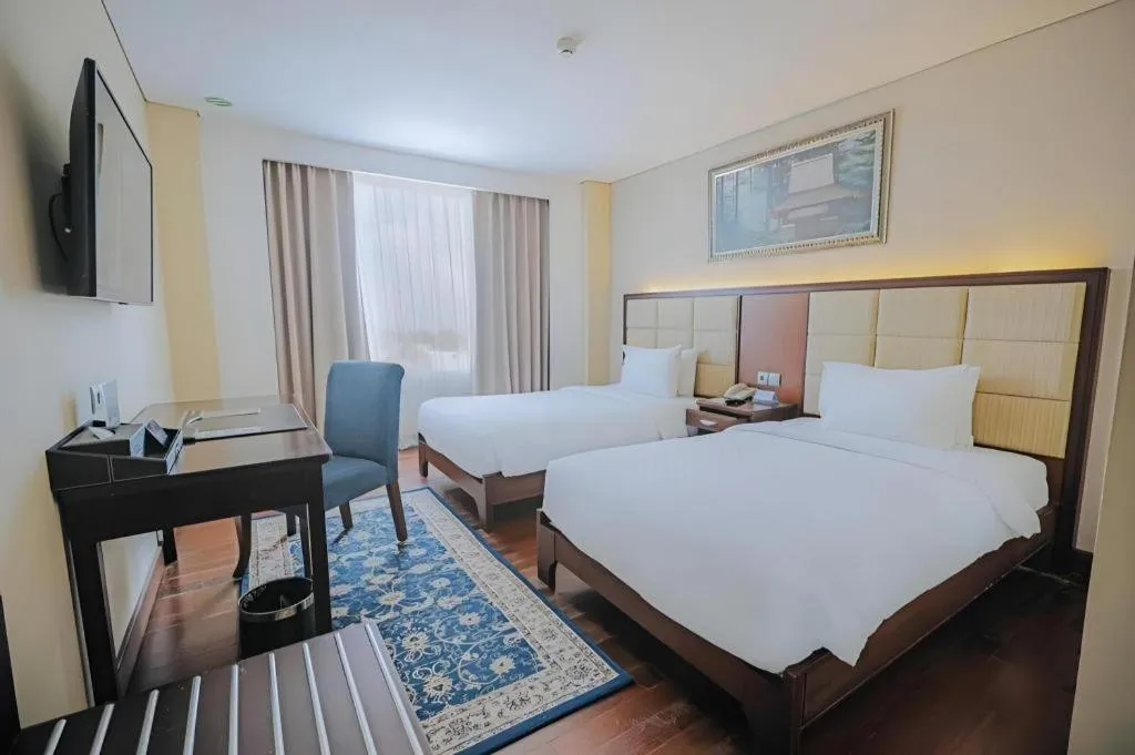 Bed in Grand Qin Hotel Syariah