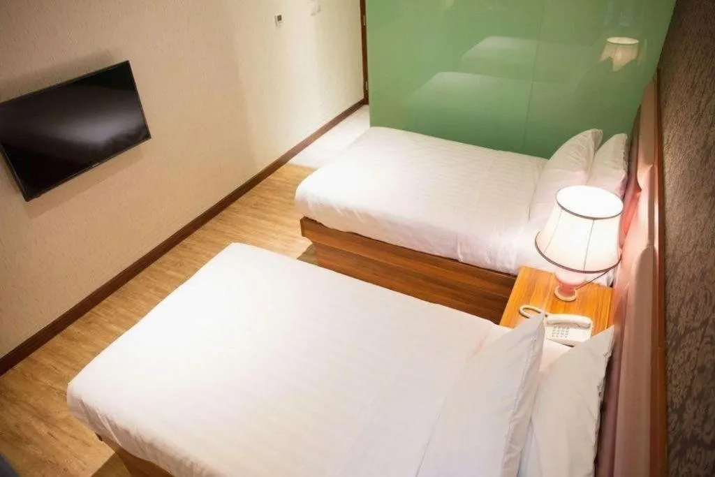 Bed in Metro Winner Hotel