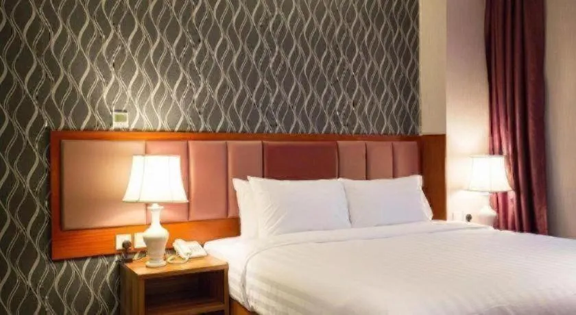 Bed in Metro Winner Hotel