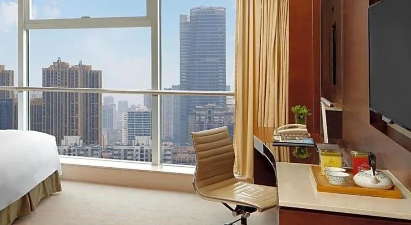 Bed in New World Wuhan Hotel