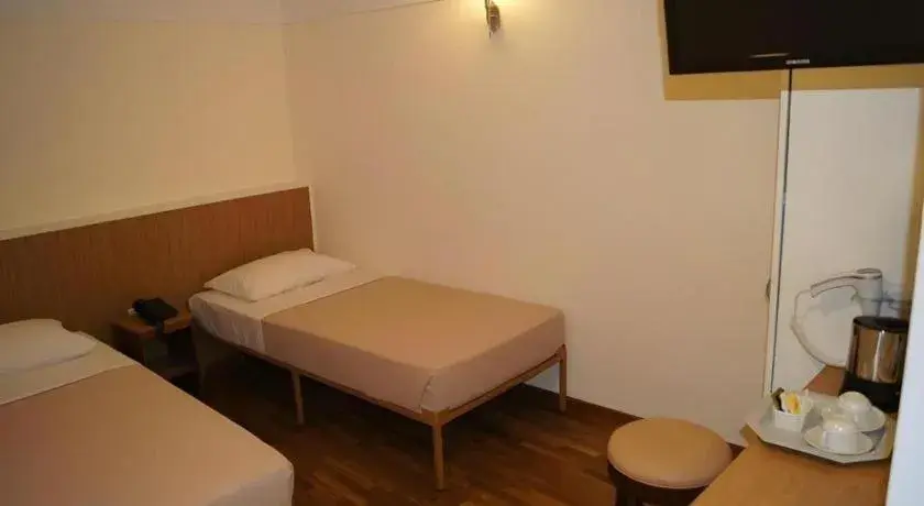 Bed in Arianna Hotel Bed in Arianna Hotel