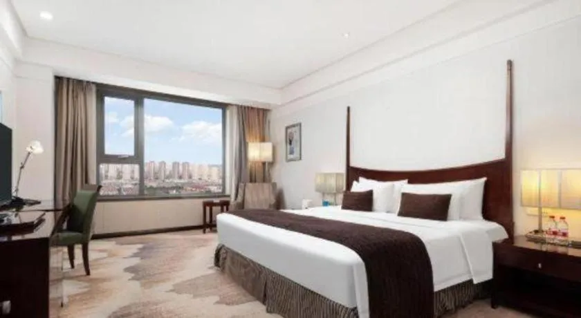 Bed in Grand New Century Hotel Binhai Tianjin