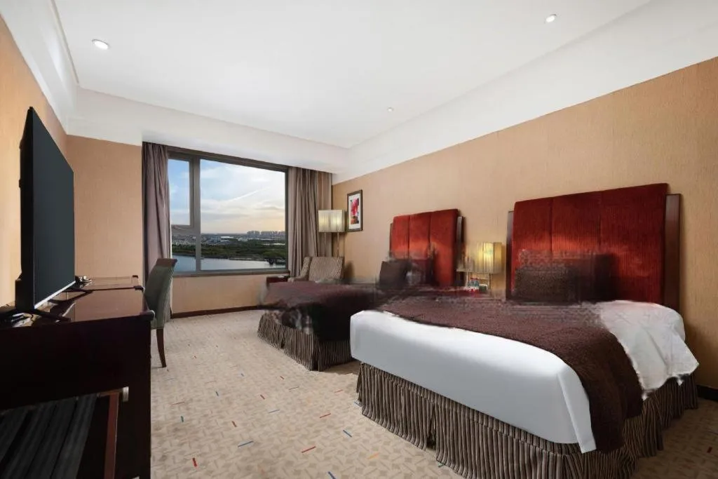 Bed in Grand New Century Hotel Binhai Tianjin