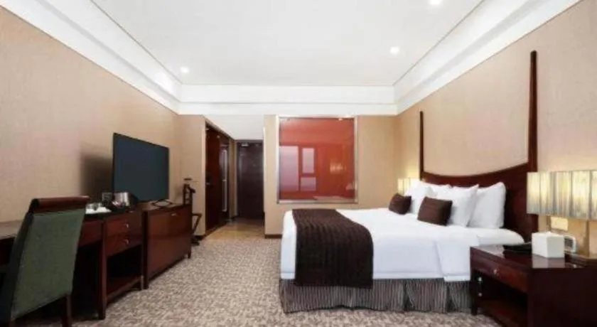 Bed in Grand New Century Hotel Binhai Tianjin