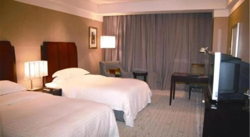 Bed in Grand New Century Hotel Binhai Tianjin