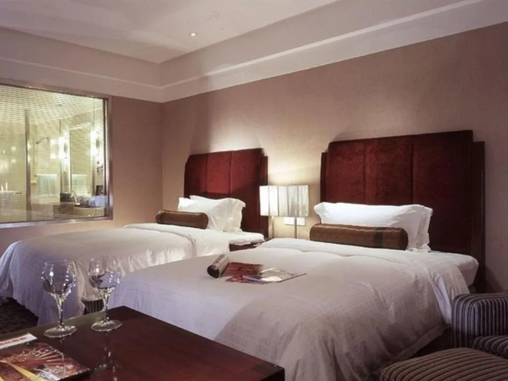 Bed in Grand New Century Hotel Binhai Tianjin