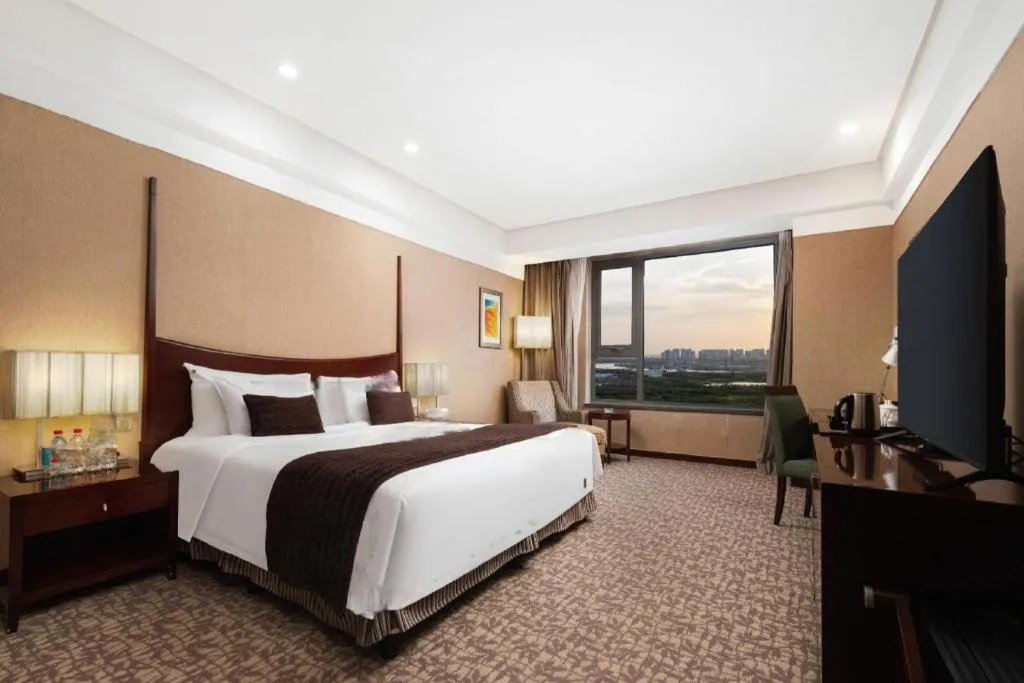 Bed in Grand New Century Hotel Binhai Tianjin