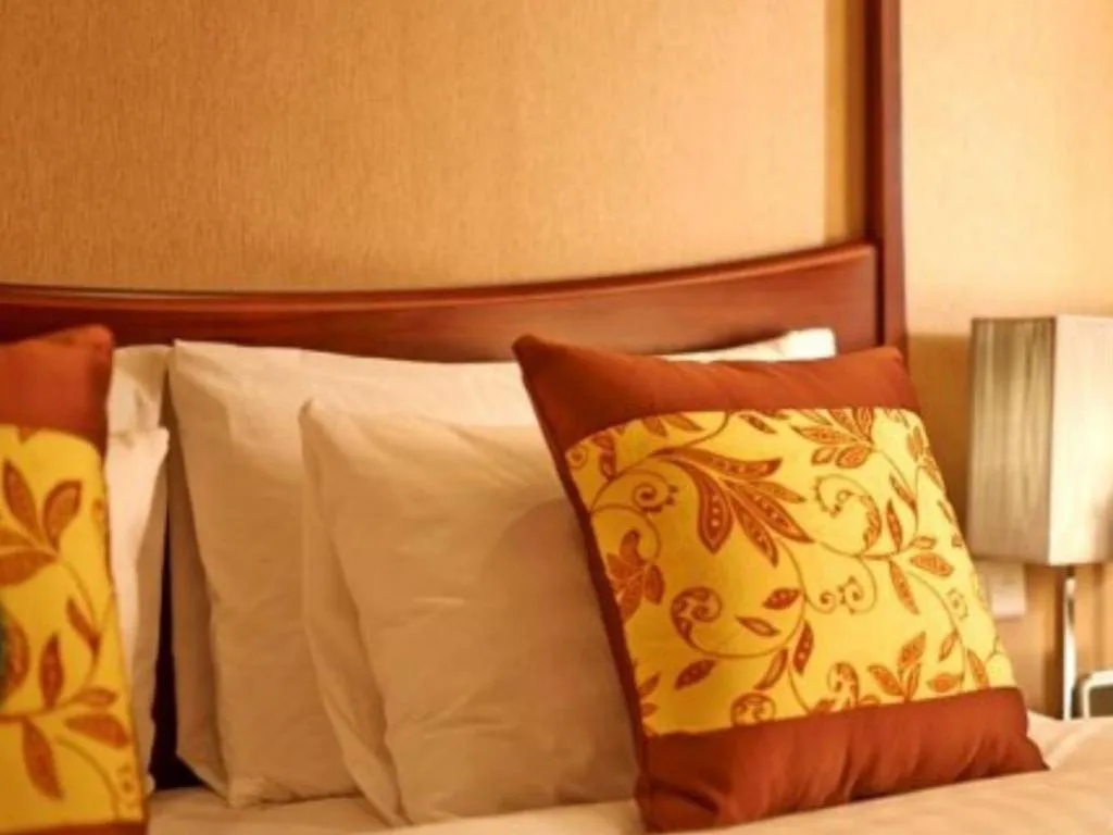 Bed in Grand New Century Hotel Binhai Tianjin