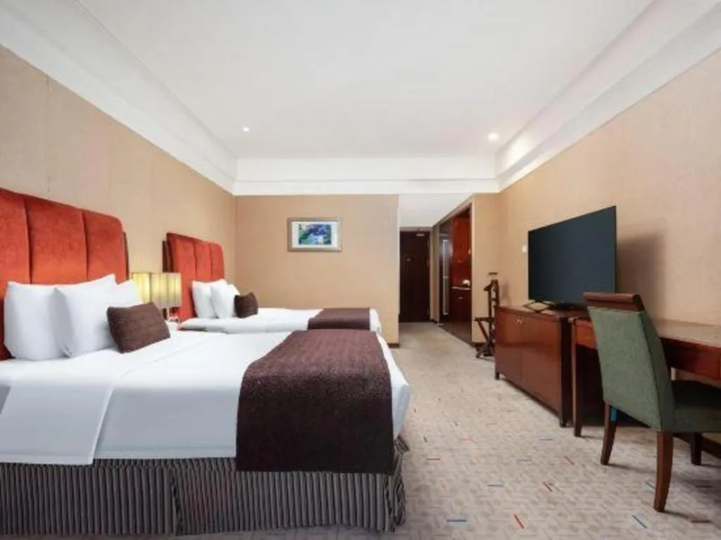 Bed in Grand New Century Hotel Binhai Tianjin