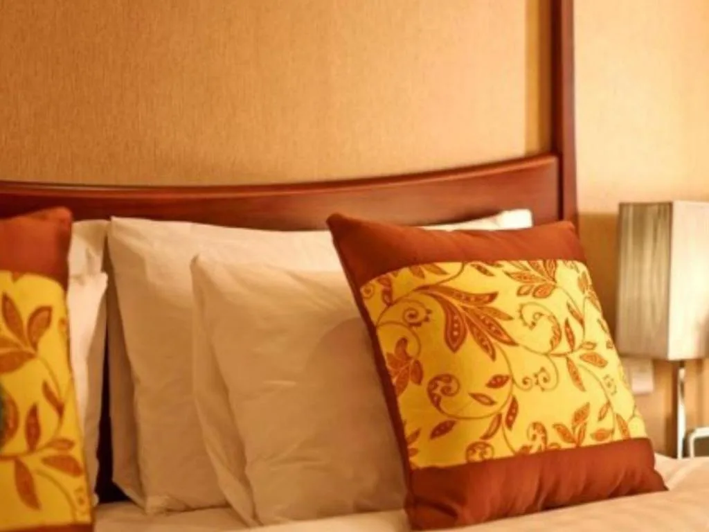 Bed in Grand New Century Hotel Binhai Tianjin