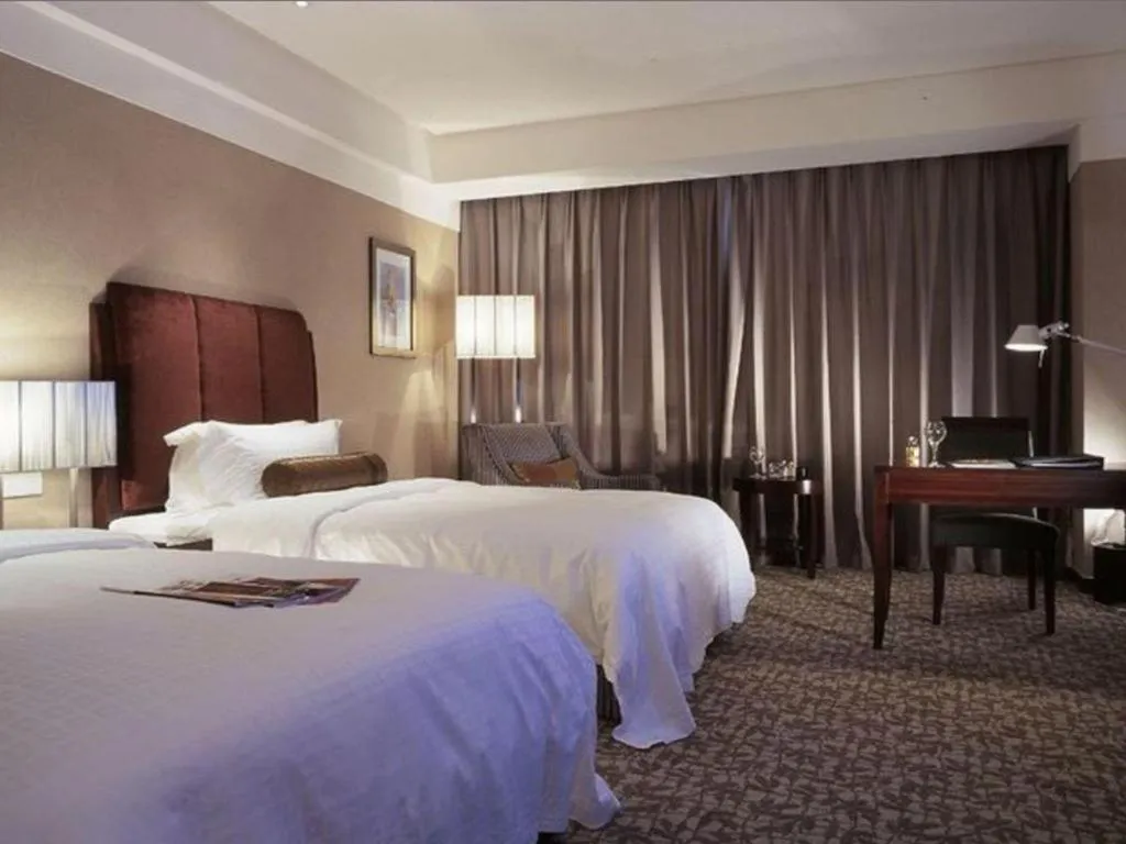 Bed in Grand New Century Hotel Binhai Tianjin