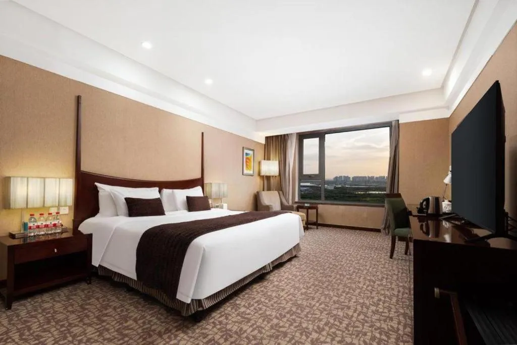 Bed in Grand New Century Hotel Binhai Tianjin