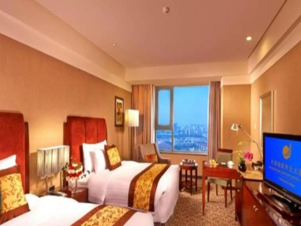 Bed in Grand New Century Hotel Binhai Tianjin