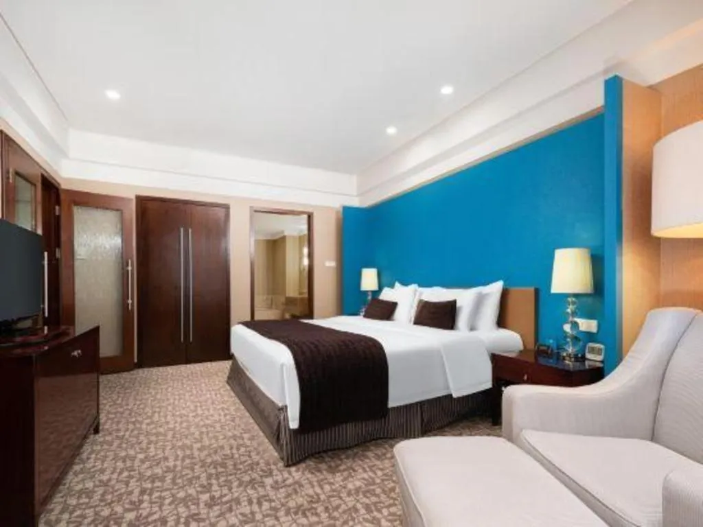 Bed in Grand New Century Hotel Binhai Tianjin