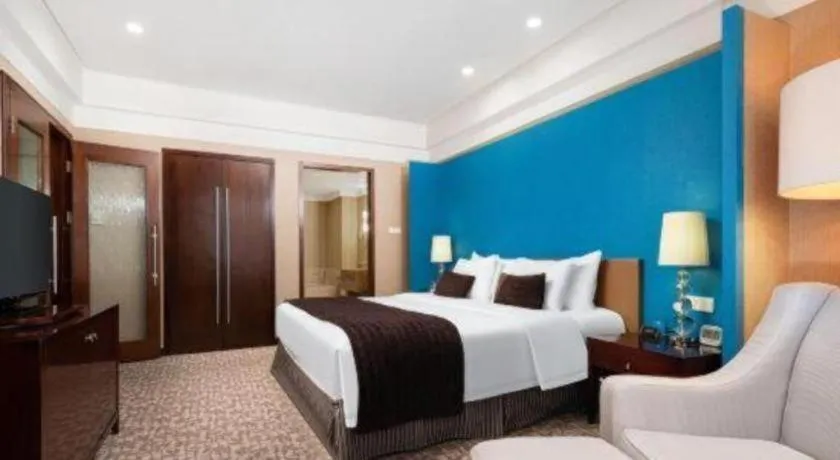 Bed in Grand New Century Hotel Binhai Tianjin