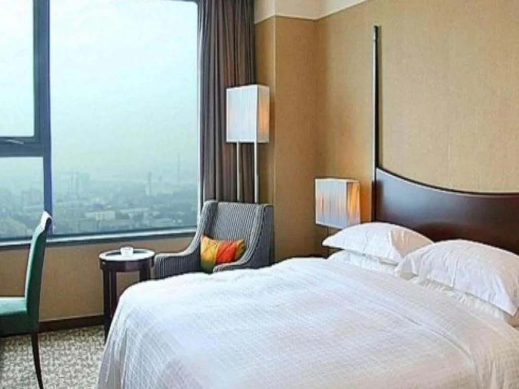 Bed in Grand New Century Hotel Binhai Tianjin