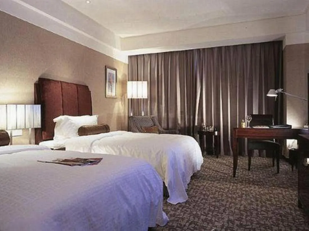 Bed in Grand New Century Hotel Binhai Tianjin