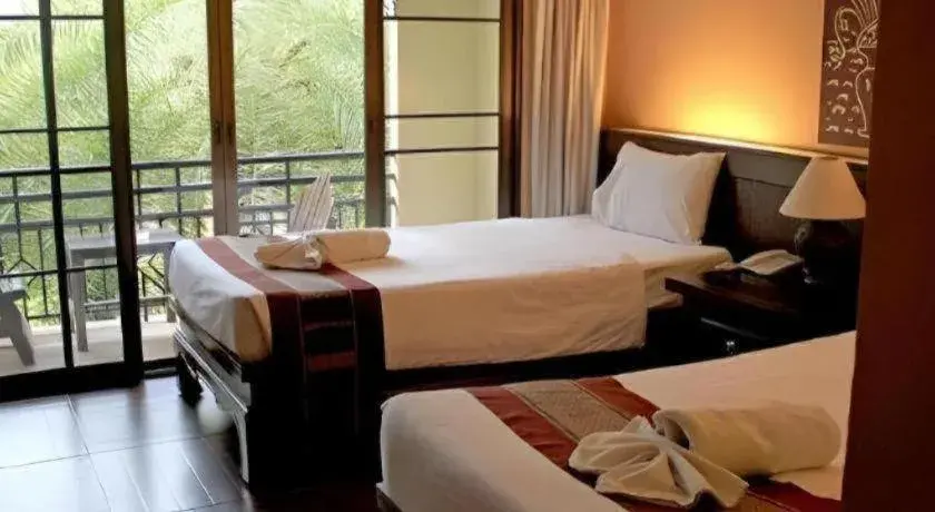 Bed in PhoomThai Garden Hotel Bed in PhoomThai Garden Hotel