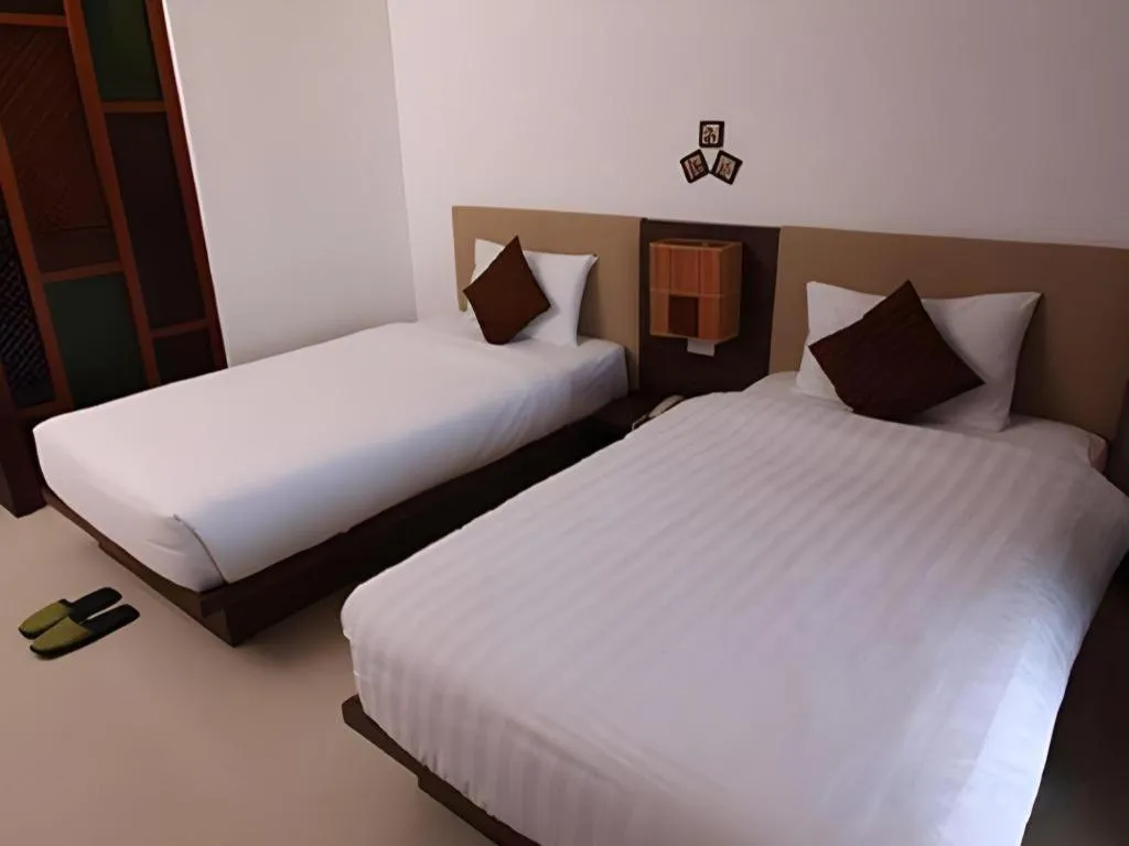 Bed in PhoomThai Garden Hotel