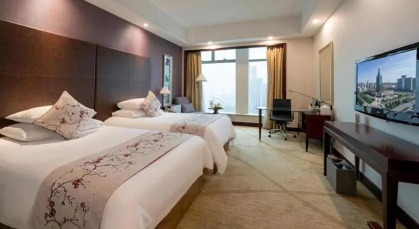 Bed in New Century Grand Hotel Zhuji Yaojiang
