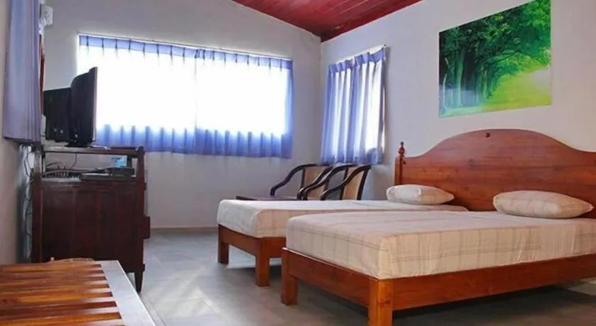 Bed in OYO 246 Roy Villa Beach Hotel