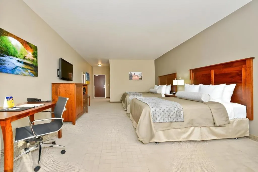 Bed in Green Mill Village Hotel & Suites, BW Signature Collection