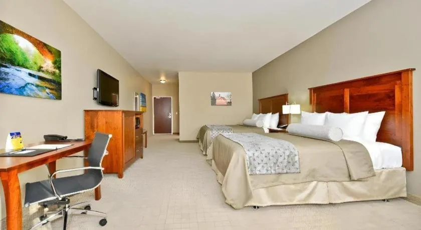 Bed in Green Mill Village Hotel & Suites, BW Signature Collection