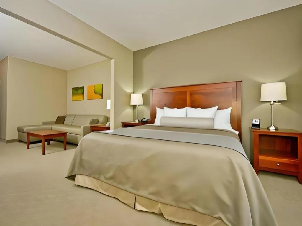 Bed in Green Mill Village Hotel & Suites, BW Signature Collection