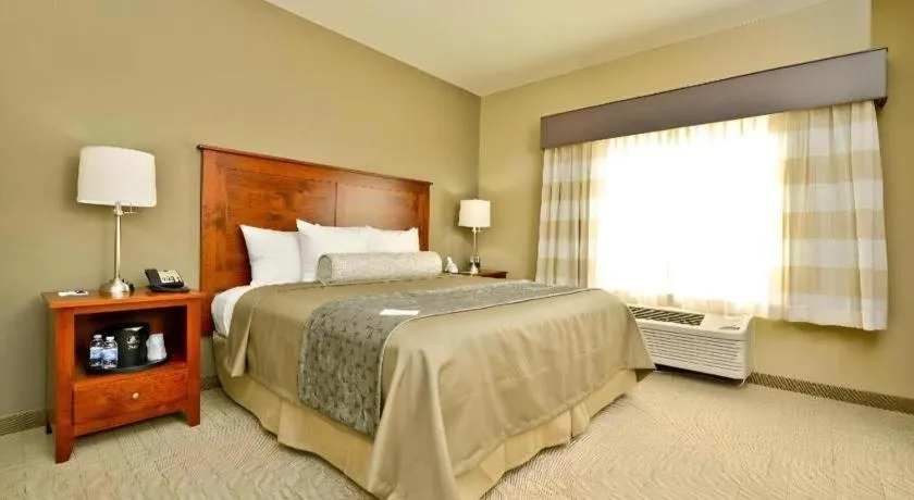 Bed in Green Mill Village Hotel & Suites, BW Signature Collection