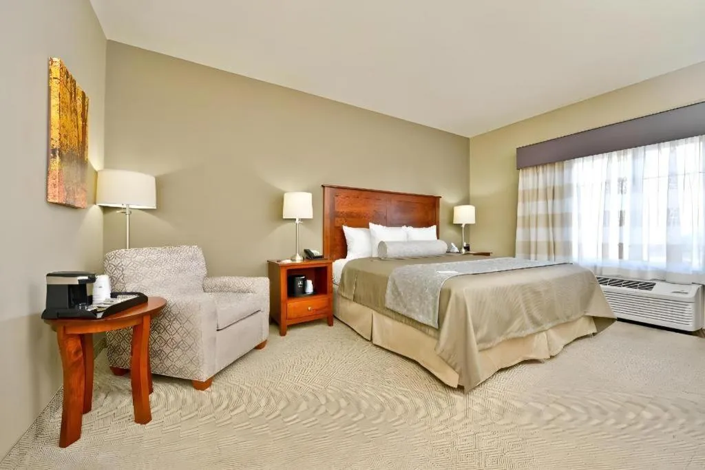 Bed in Green Mill Village Hotel & Suites, BW Signature Collection