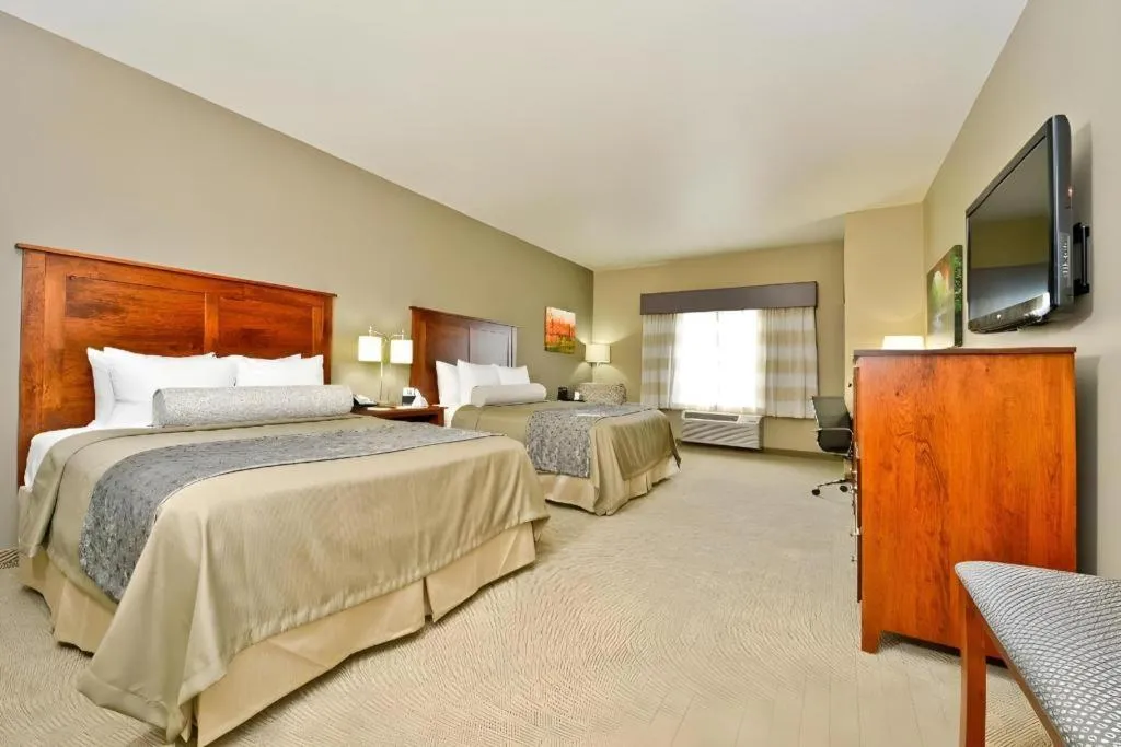 Bed in Green Mill Village Hotel & Suites, BW Signature Collection