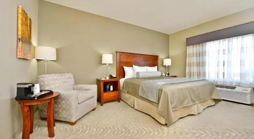 Bed in Green Mill Village Hotel & Suites, BW Signature Collection