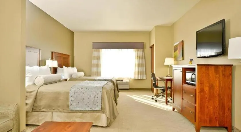 Bed in Green Mill Village Hotel & Suites, BW Signature Collection