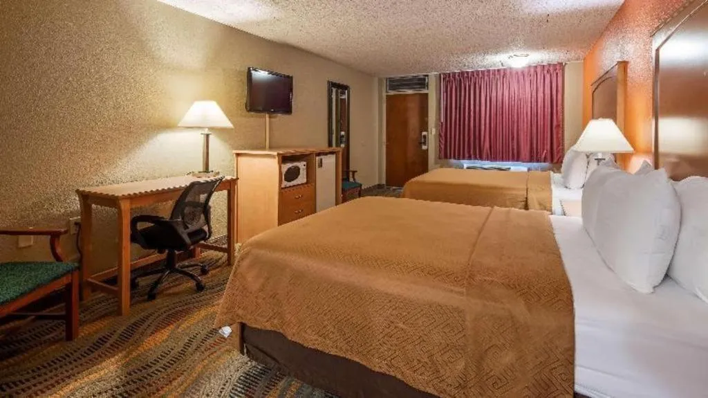 Bed in SureStay Hotel