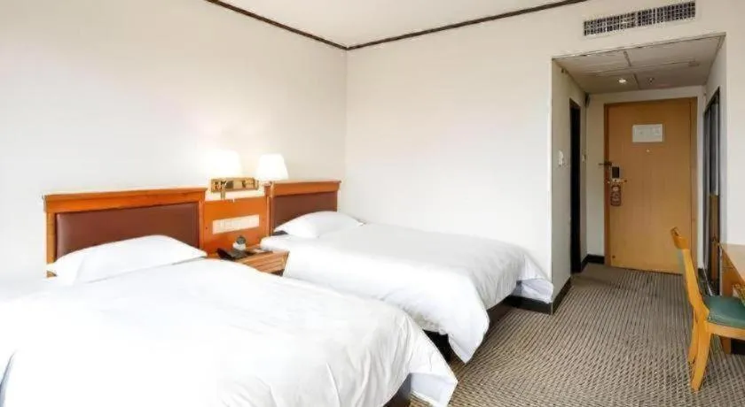 Bed in Nanfang Dasha Hotel