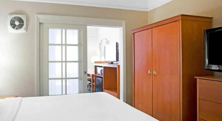 Bed in Ramada Suites by Wyndham San Diego