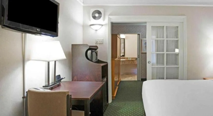 Bed in Ramada Suites by Wyndham San Diego