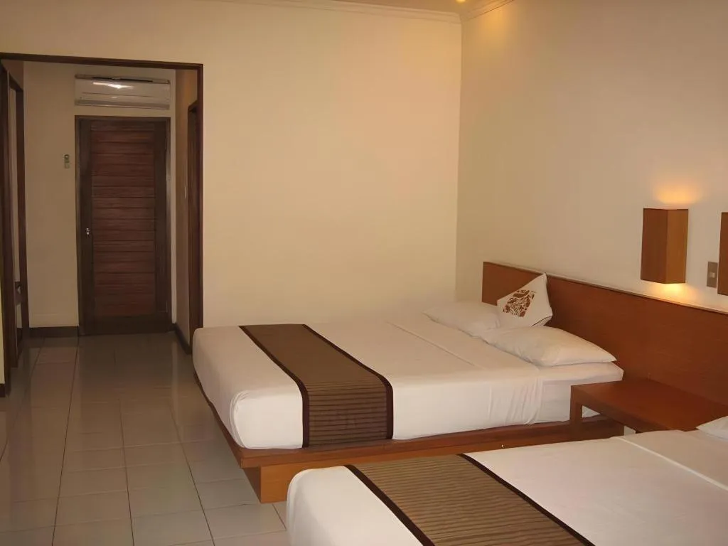 Bed in Nyiur Resort Hotel