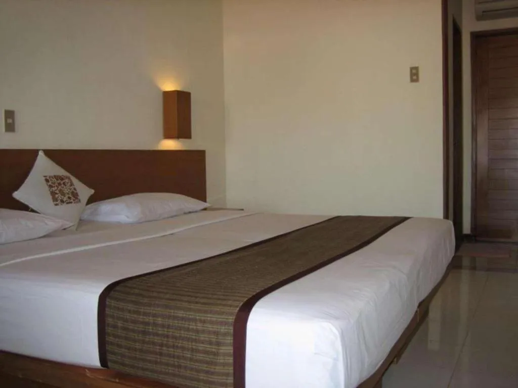 Bed in Nyiur Resort Hotel