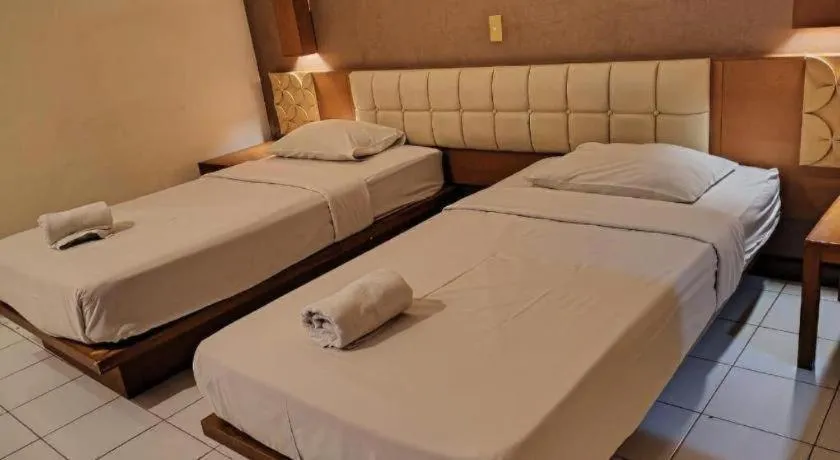 Bed in Nyiur Resort Hotel